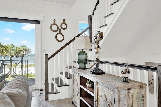 7 Marden Dr, Ormond Beach, FL 32176 - stairs featuring a water view, crown molding, and tile patterned flooring