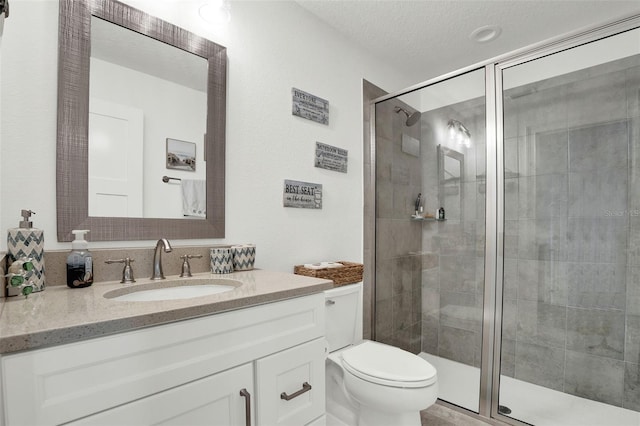 7 Marden Dr, Ormond Beach, FL 32176 - bathroom featuring a stall shower, a textured ceiling, vanity, and toilet