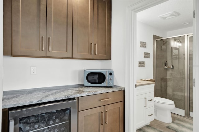7 Marden Dr, Ormond Beach, FL 32176 - kitchen with beverage cooler and light stone counters