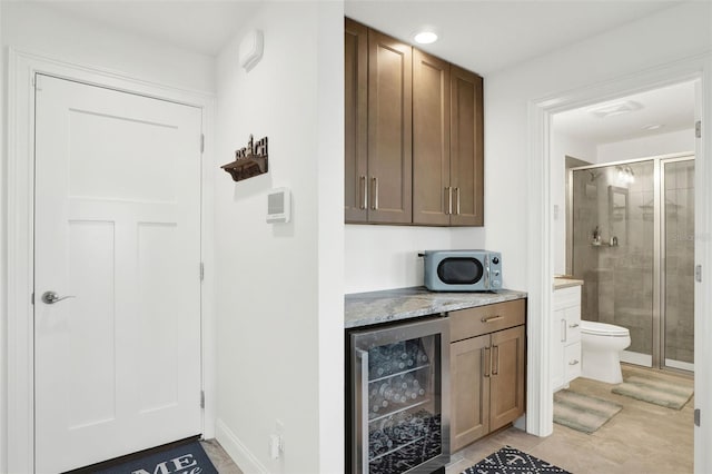 7 Marden Dr, Ormond Beach, FL 32176 - bar with beverage cooler and light tile patterned floors