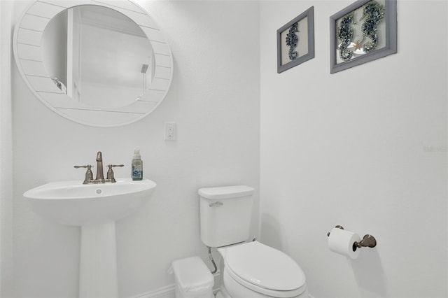7 Marden Dr, Ormond Beach, FL 32176 - half bathroom with toilet, baseboards, and a sink