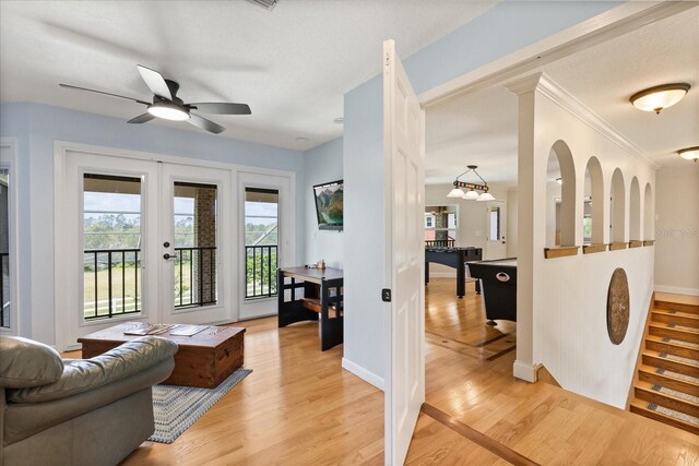 living room featuring a ceiling fan, baseboards, french doors, and light wood finished floors