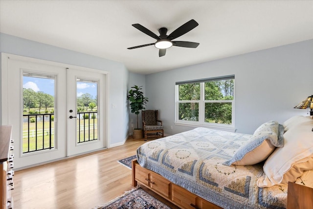 bedroom featuring access to exterior, light wood-style floors, baseboards, french doors, and a ceiling fan
