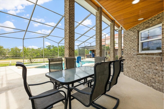 view of patio / terrace with a pool with connected hot tub, a lanai, and outdoor dining area