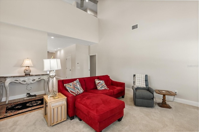 living area with carpet flooring, baseboards, and visible vents