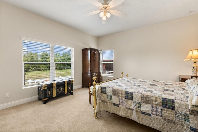bedroom featuring baseboards, light carpet, and ceiling fan