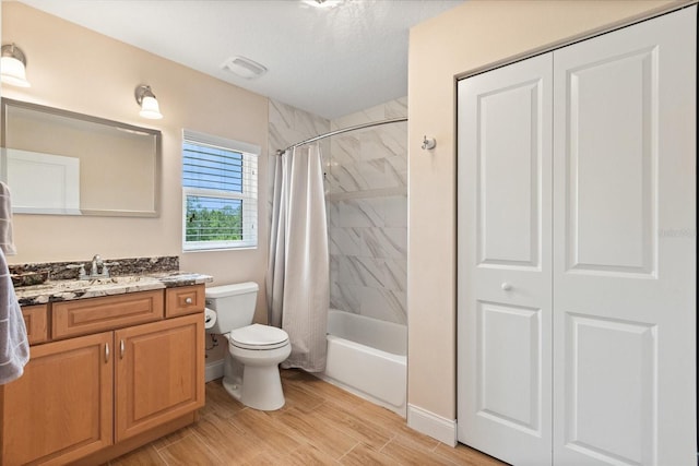 full bathroom with vanity, toilet, shower / bath combination with curtain, wood finished floors, and a closet