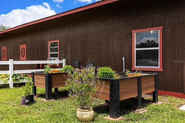 view of home's exterior featuring a vegetable garden and metal roof
