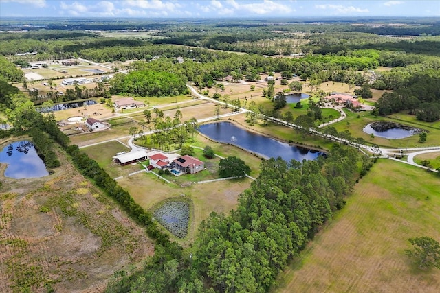 aerial view featuring a water view and a wooded view