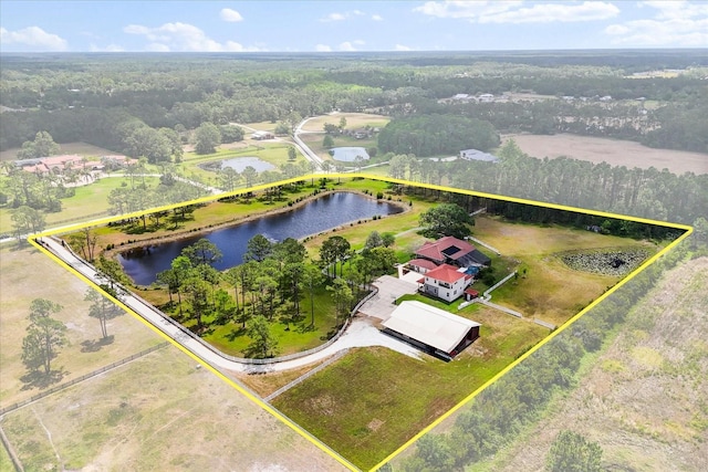 drone / aerial view with a water view and a forest view