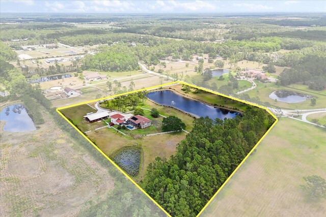 bird's eye view with a water view and a wooded view