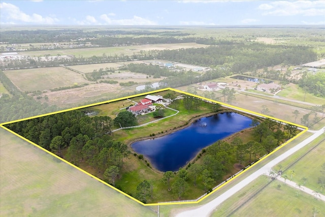 birds eye view of property featuring a water view and a forest view