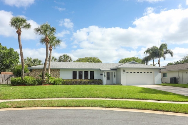 single story home with a garage, driveway, central AC, and a front yard