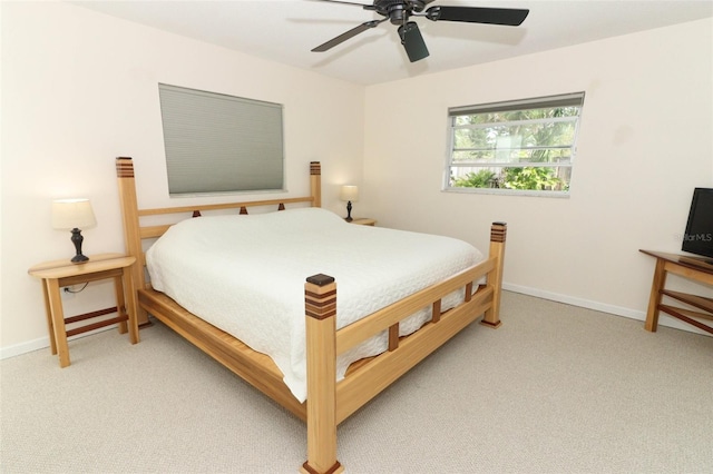 bedroom featuring baseboards, a ceiling fan, and light colored carpet