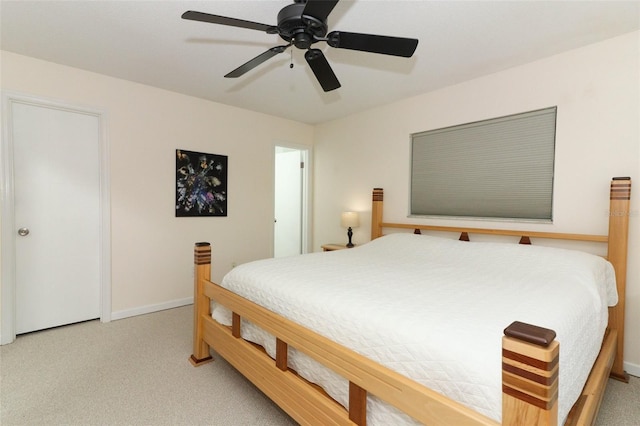 carpeted bedroom with baseboards and a ceiling fan