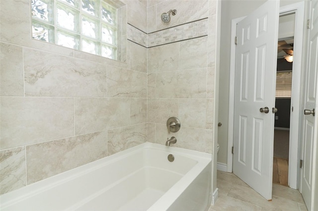 bathroom featuring tile patterned flooring, bathtub / shower combination, and toilet