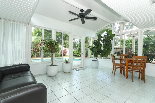 sunroom with tile patterned flooring, lofted ceiling with beams, and visible vents