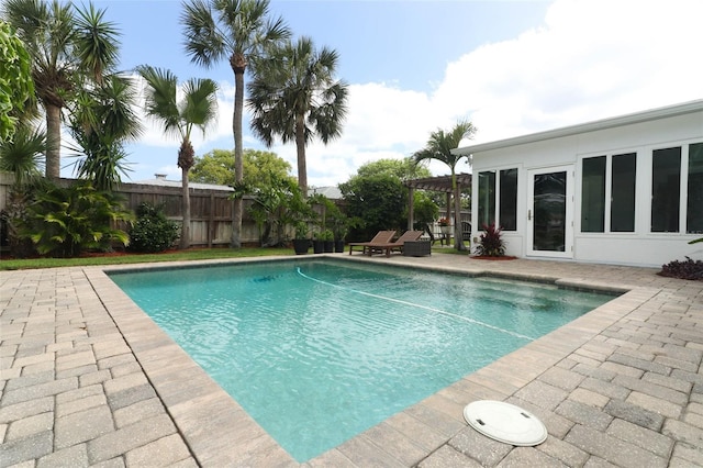 view of pool with a fenced in pool, fence, and a patio