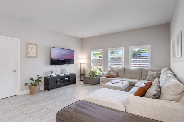 living room with baseboards and visible vents