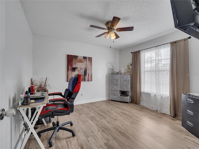 office area with baseboards, a ceiling fan, a textured ceiling, and wood finished floors