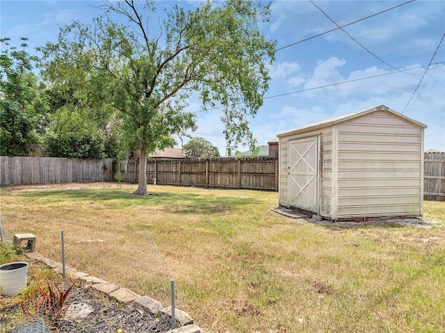 view of yard featuring a fenced backyard, an outdoor structure, and a storage shed