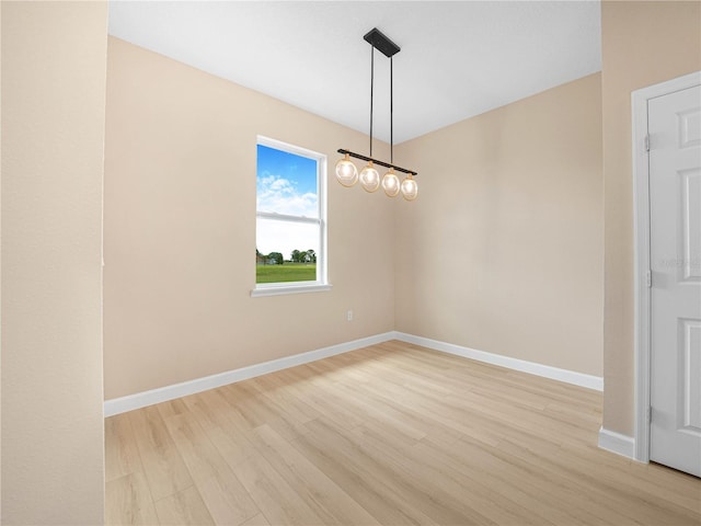 unfurnished room featuring light wood-style flooring and baseboards