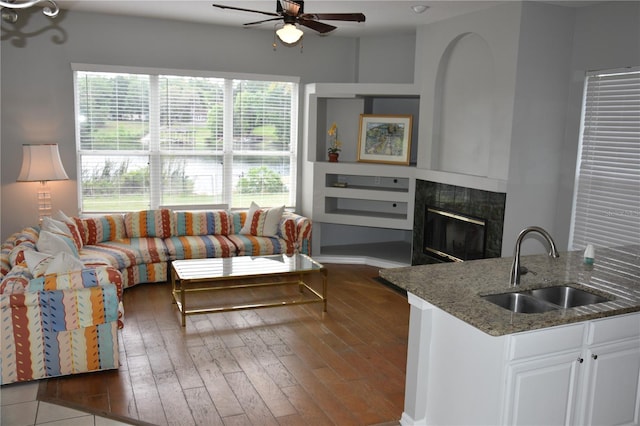 7508 Lake Marsha Dr, Orlando, FL 32819 - living room featuring ceiling fan, a fireplace, and hardwood / wood-style flooring