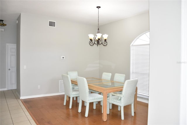 7508 Lake Marsha Dr, Orlando, FL 32819 - dining area featuring light wood-style floors, baseboards, a notable chandelier, and visible vents