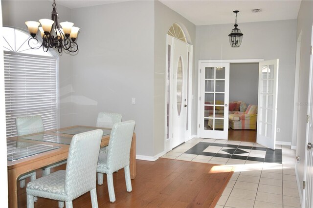 7508 Lake Marsha Dr, Orlando, FL 32819 - dining room featuring a notable chandelier, tile patterned floors, french doors, baseboards, and visible vents