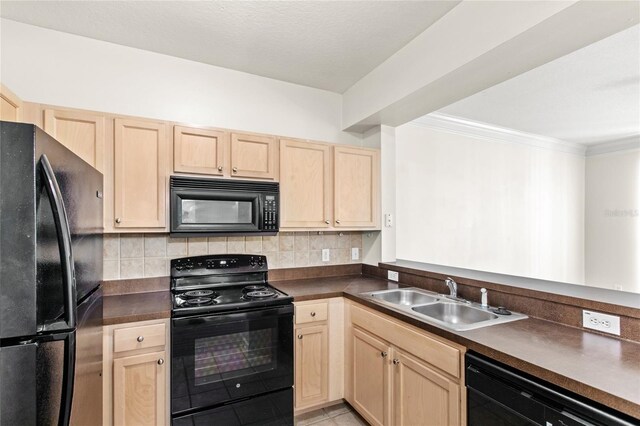12843 Madison Pointe Cir Unit 106, Orlando, FL 32821 - kitchen with a sink, light brown cabinetry, black appliances, and dark countertops