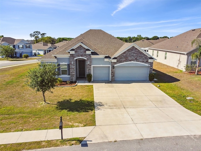 ranch-style house featuring driveway, roof with shingles, a garage, a front lawn, and stone siding
