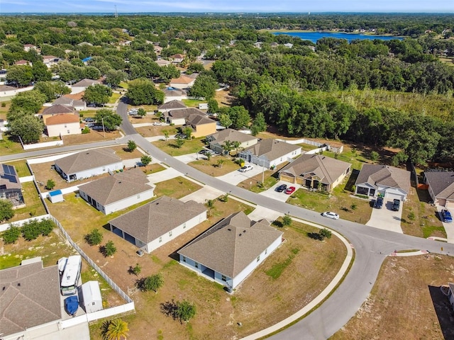 drone / aerial view with a water view and a residential view
