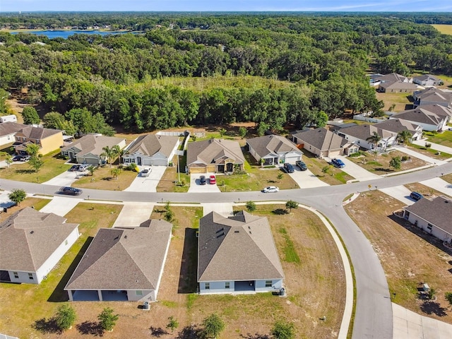 drone / aerial view featuring a view of trees and a residential view