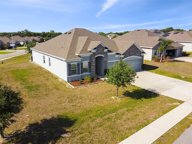 single story home with concrete driveway, a shingled roof, and a front lawn