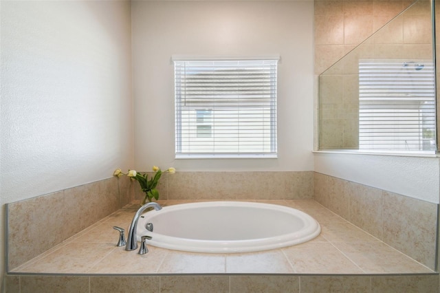bathroom with plenty of natural light and a garden tub