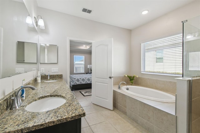full bathroom with a sink, tile patterned floors, a garden tub, and visible vents