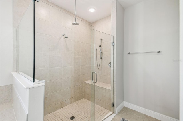 bathroom featuring tile patterned floors and a shower stall