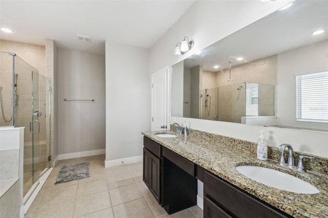 full bathroom with a sink, a stall shower, and visible vents