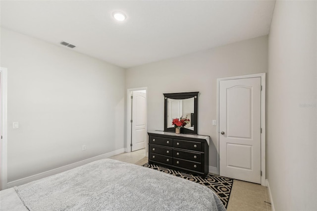 bedroom featuring light tile patterned floors, baseboards, and visible vents