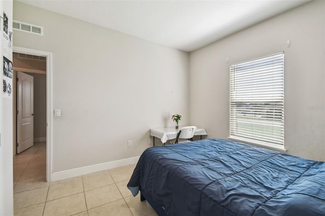 bedroom featuring visible vents, baseboards, and light tile patterned flooring