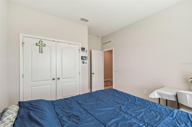 bedroom with visible vents and a closet