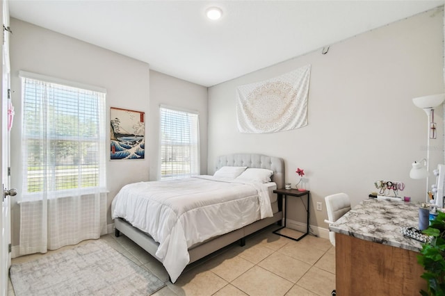 bedroom featuring baseboards and light tile patterned flooring