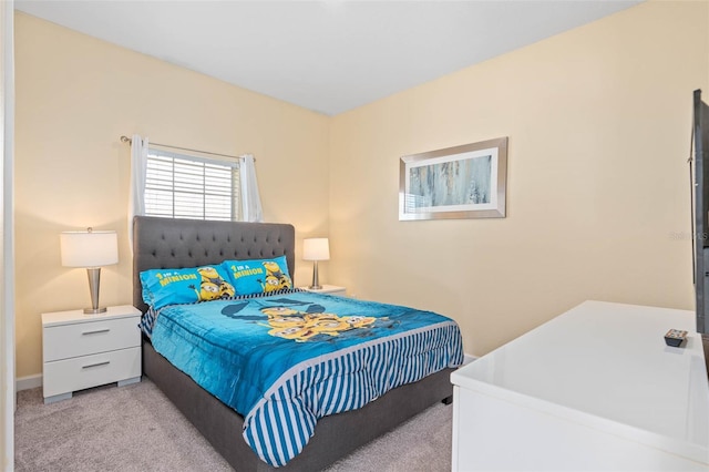 bedroom featuring baseboards and light carpet