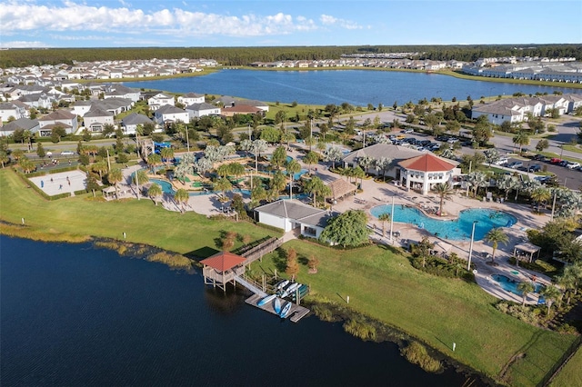 drone / aerial view with a residential view and a water view