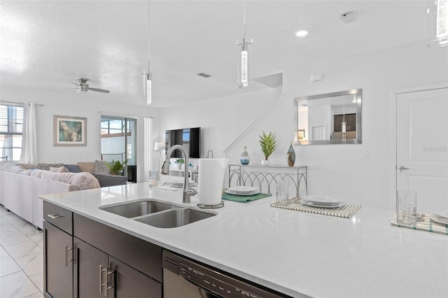 kitchen with a sink, a wealth of natural light, open floor plan, and light countertops