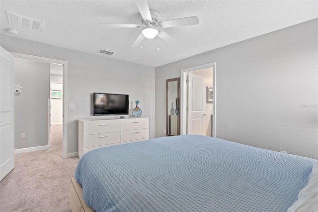 bedroom featuring visible vents, a ceiling fan, baseboards, and light carpet