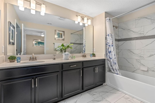 bathroom with shower / bath combo with shower curtain, a sink, marble finish floor, and double vanity