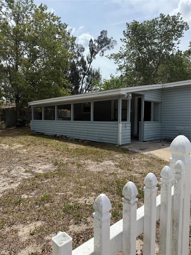 1238 Lakecrest Dr, Apopka, FL 32703 - view of property exterior featuring a sunroom and fence