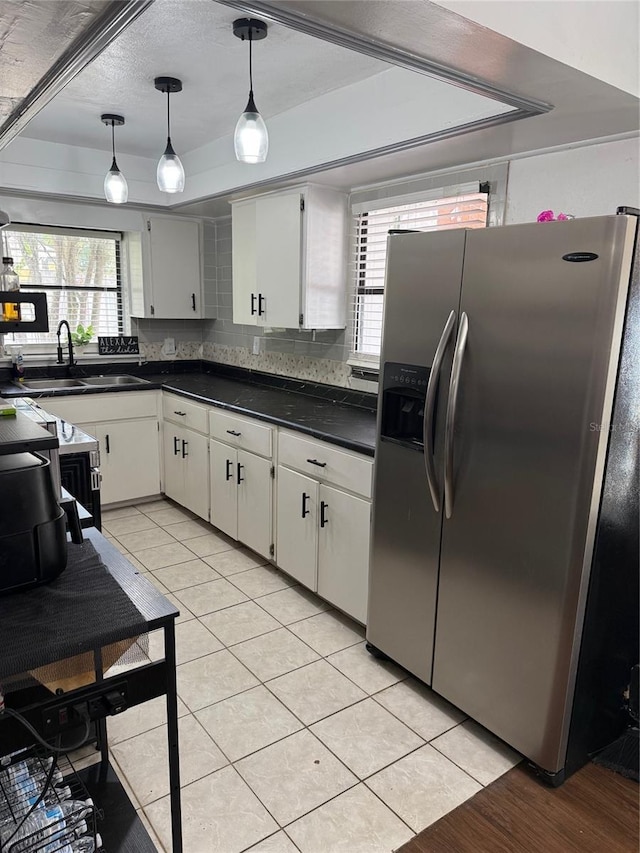 1238 Lakecrest Dr, Apopka, FL 32703 - kitchen featuring stainless steel refrigerator with ice dispenser, a sink, dark countertops, light tile patterned floors, and a tray ceiling