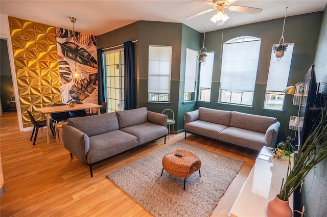 living room with a healthy amount of sunlight, a ceiling fan, and wood finished floors